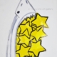 Disegno su carta di Futurboba con squalo e stelline in plastica trasparente colorata, titolo Mangio desideri