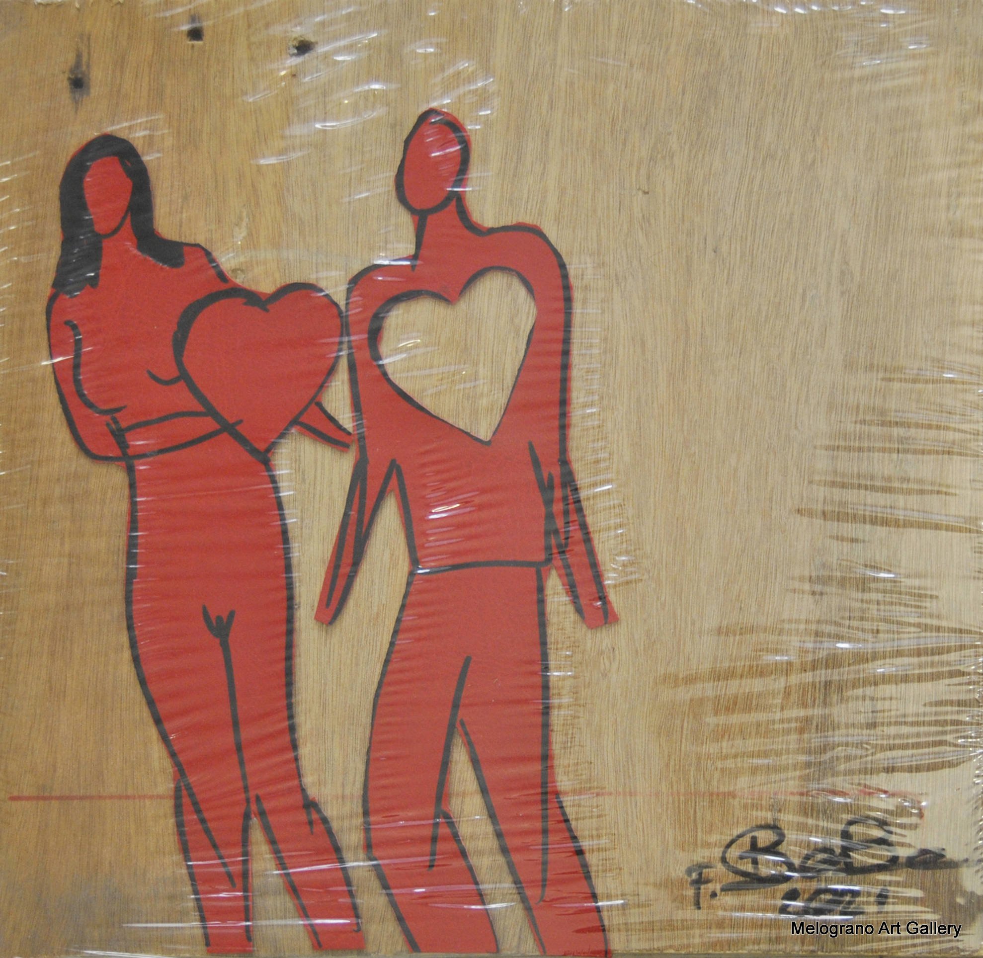 Opera di Futurboba con figurine rosse in materiale plastico su tavola coreana, sigillata sottovuoto, dedicata all’amore e alle relazioni