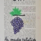 grappolo d’uva su pagina di libro con scritta uva la madre putativa del vino